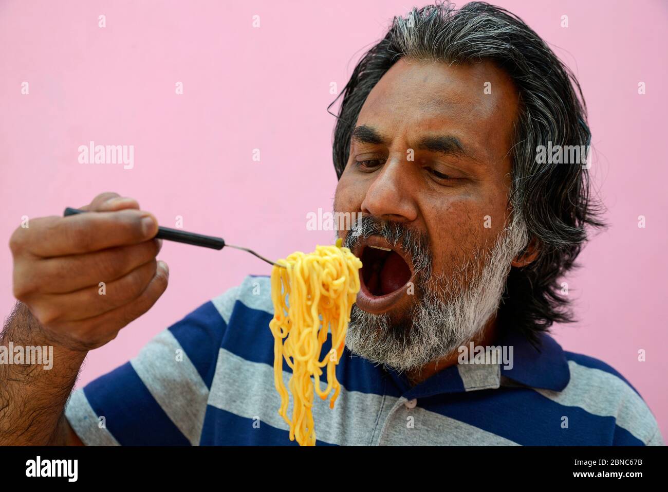 Man eating Noodles Stock Photo