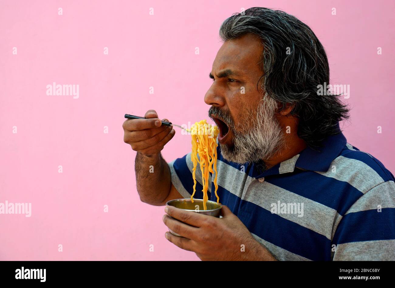 Man eating Noodles Stock Photo