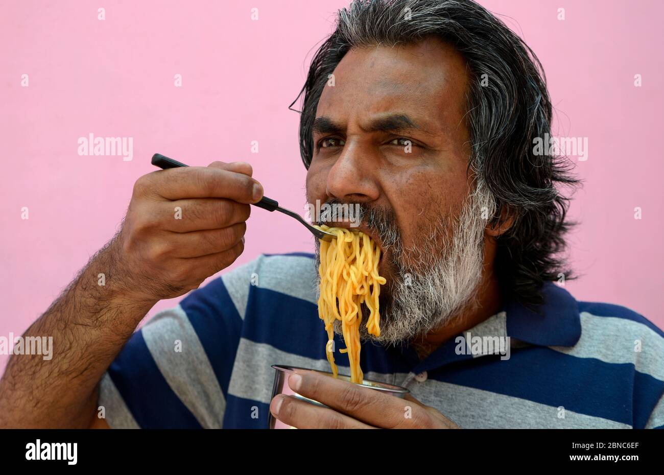 Man eating Noodles Stock Photo