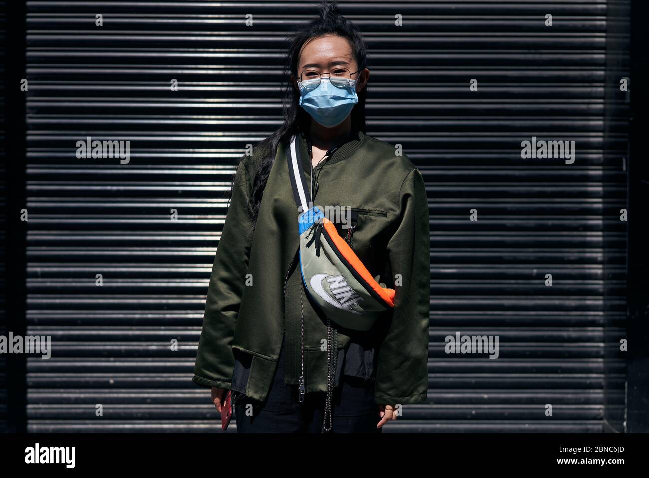 A girl wearing a facemask during the global coronavirus pandemic in Dublin city, Ireland. Stock Photo