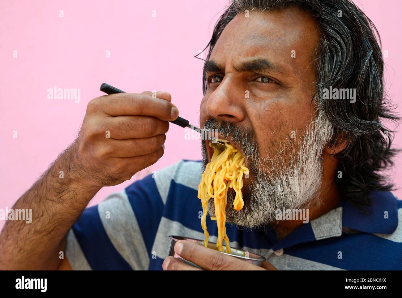 Man eating Noodles Stock Photo