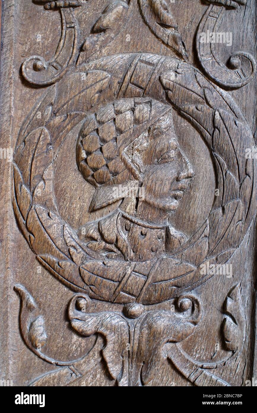Medieval carved wooden panel showing a head in profile. Stock Photo