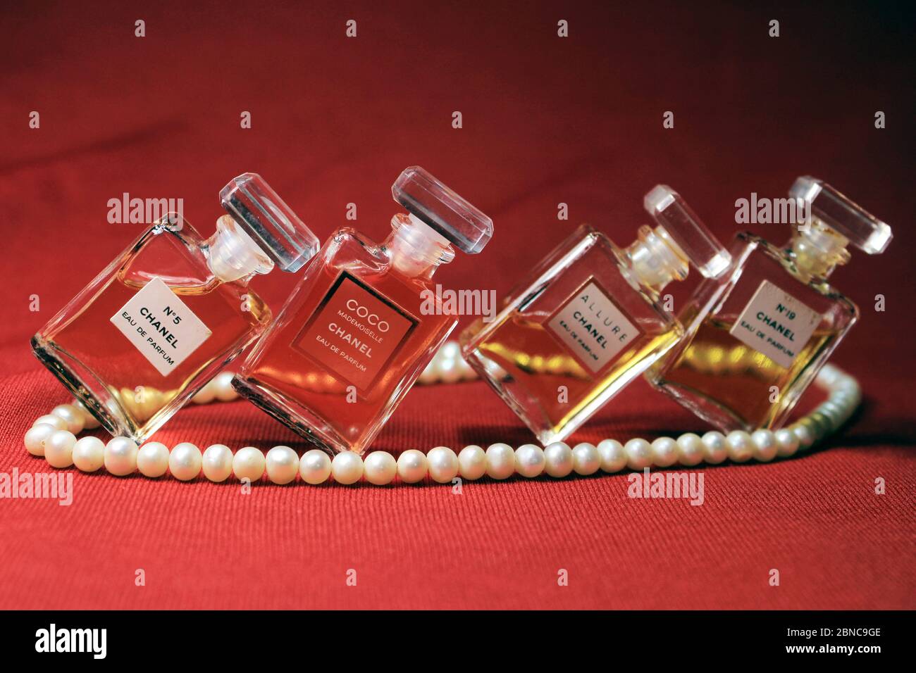 Kolkata, India on 13th May in 2020 : Chanel perfume bottles isolated on red background. Bottles with different Chanel perfume products. Stock Photo
