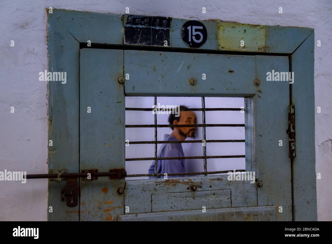 The wooden door to a jail cell in one of the wings of the Seodaemun
