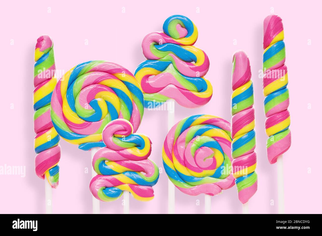 Colored Lollipops Of Different Shapes On A Pink Background. Sweet ...