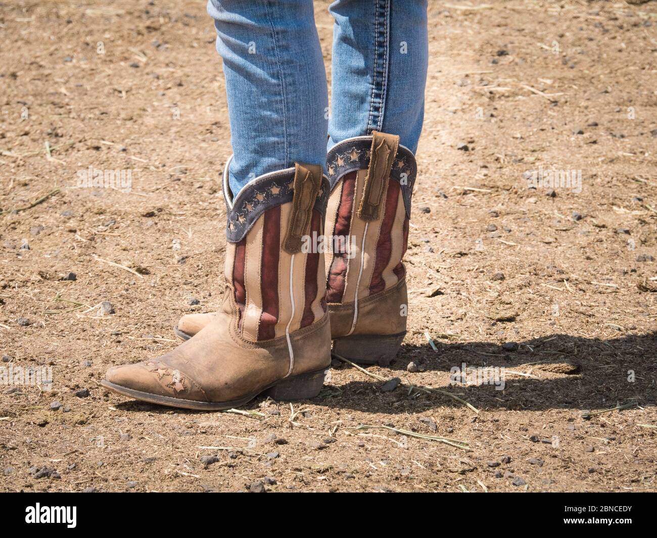 American flag cowboy boots with blue jeans tucked inside Stock Photo ...