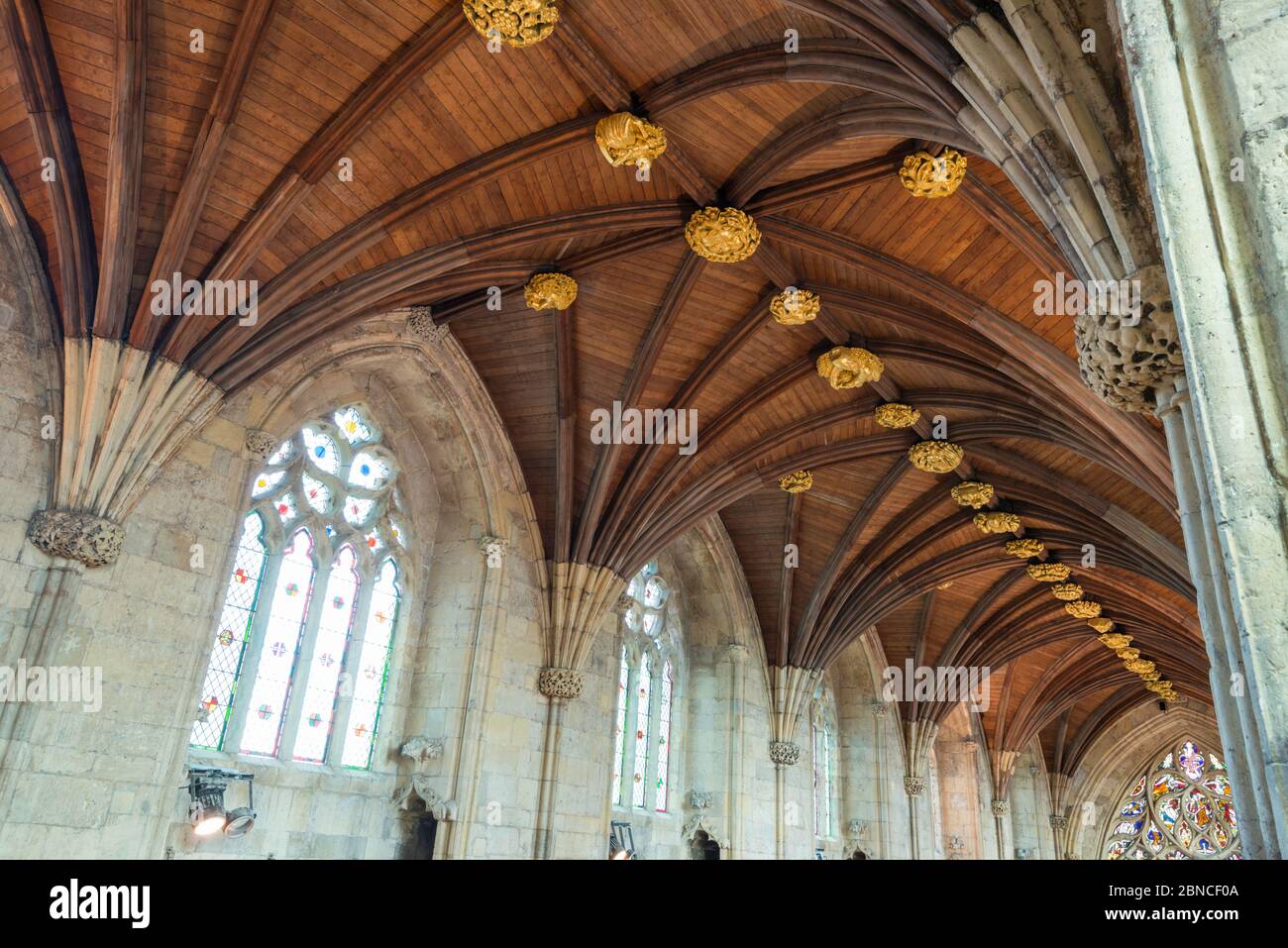 Wooden fan vaulting and gold painted roof bosses inside Selby Abbey in North Yorkshire, England Stock Photo