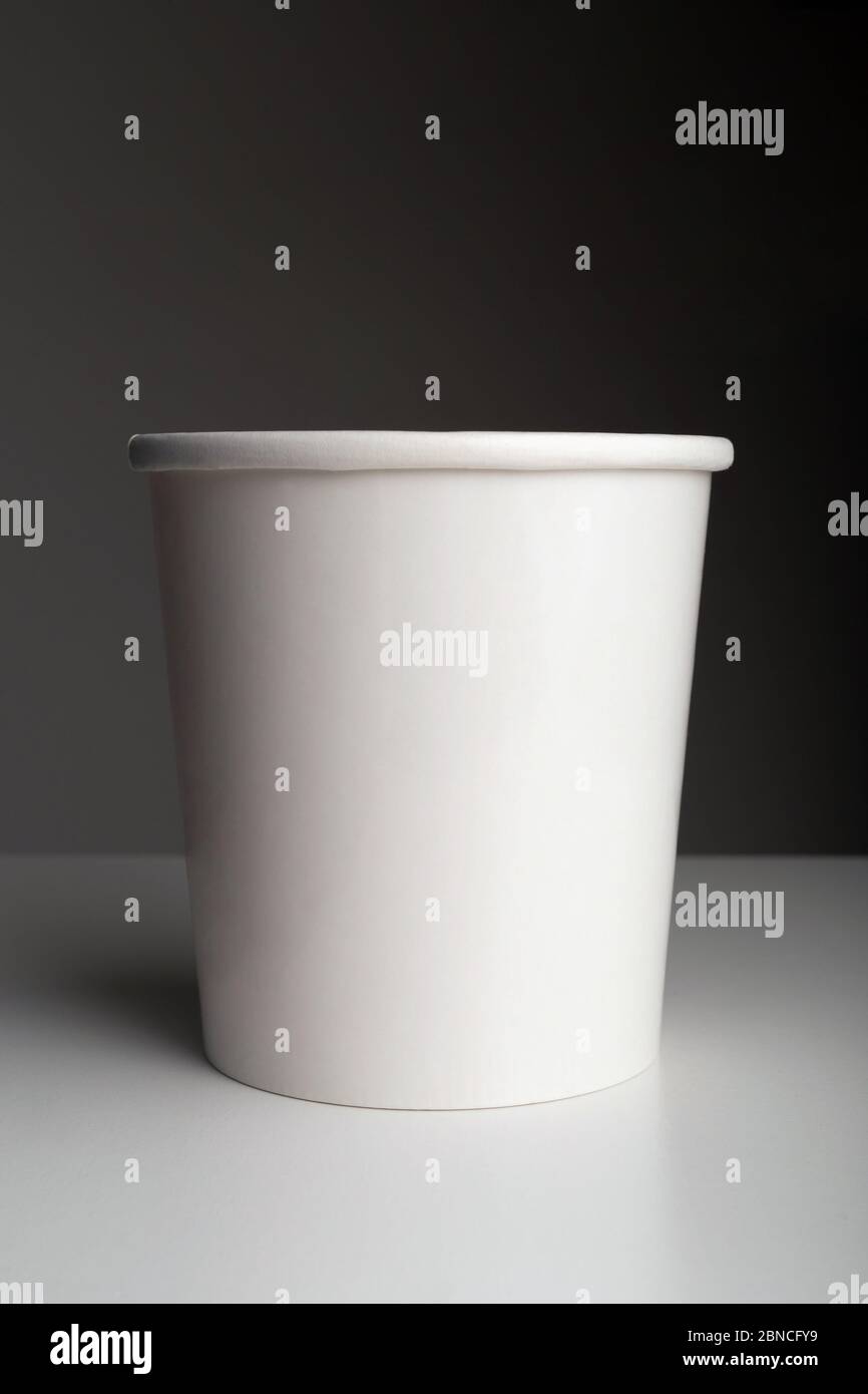 White paper coffee cup on table on dark background Stock Photo