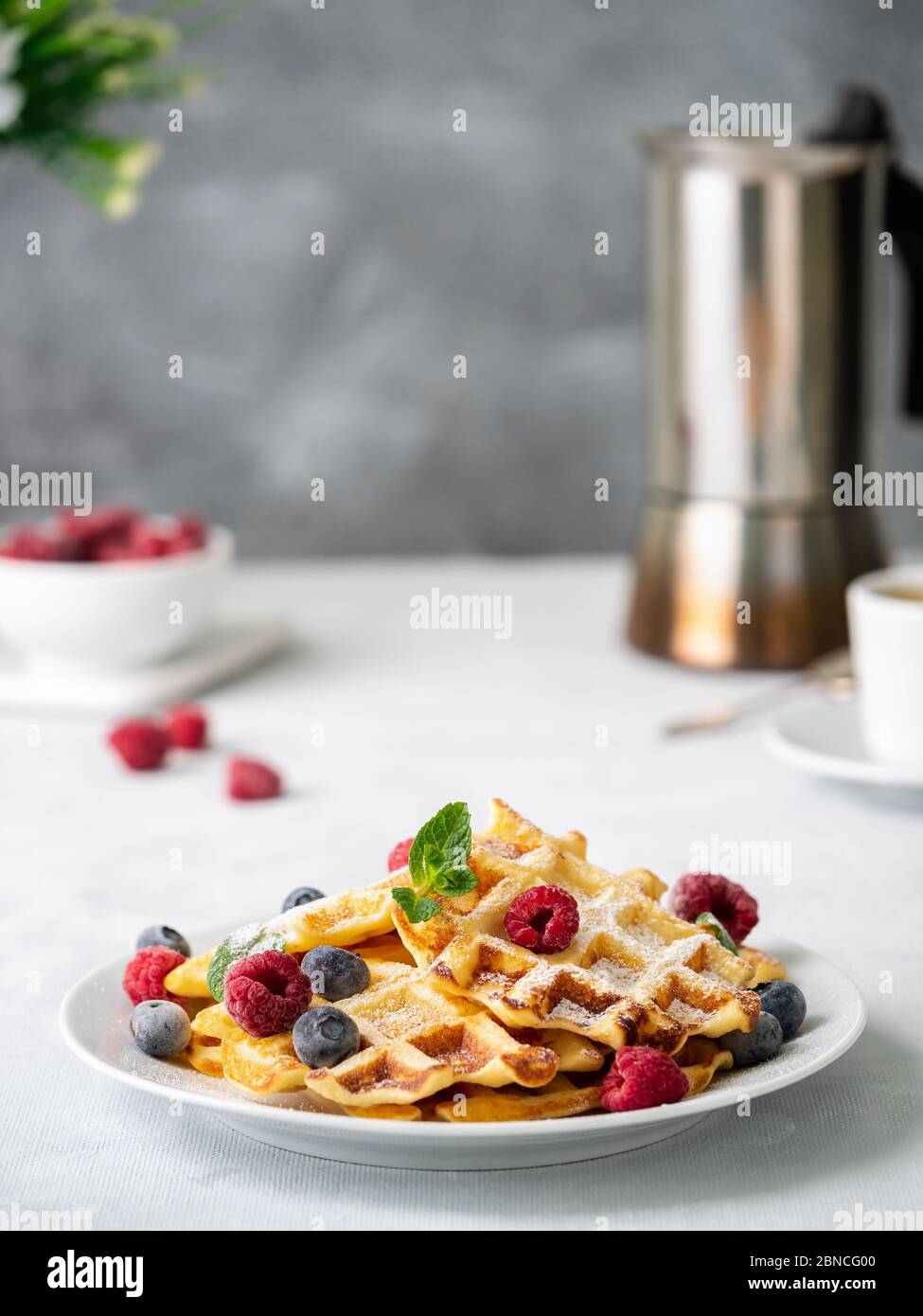 Belgian waffles with raspberries, blueberries, curd and coffee Stock