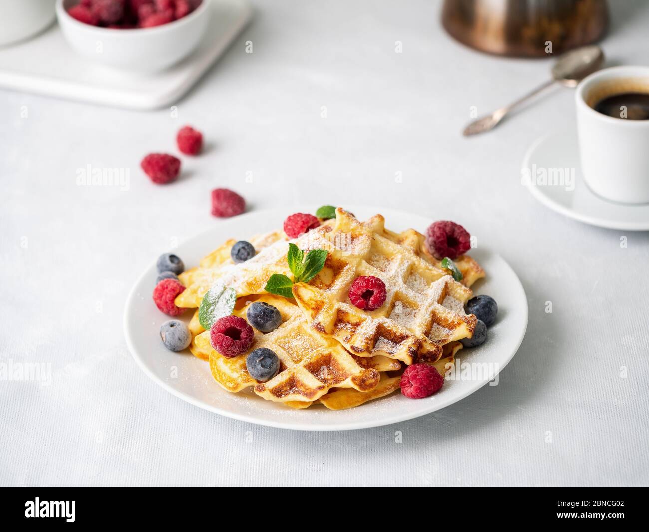 Belgian waffles with raspberries, blueberries, curd and coffee Stock