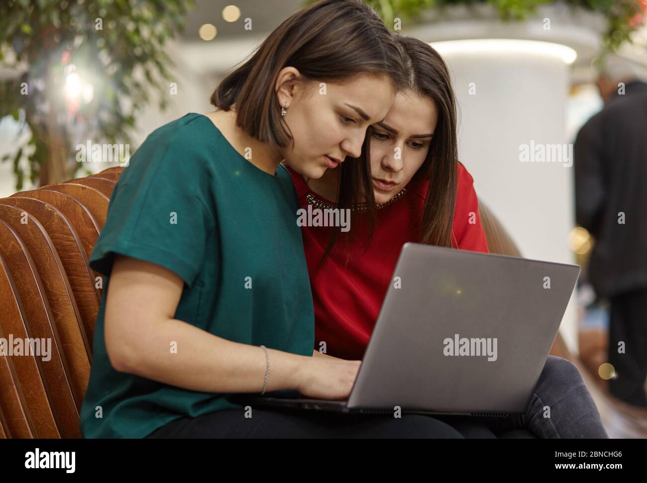 Two women students studying in open space with laptop computer Stock ...