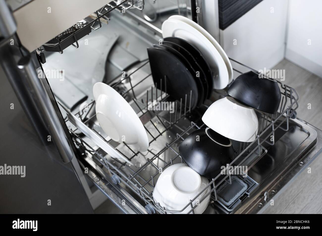 Loading dirty dishes in the dishwasher close up Stock Photo Alamy