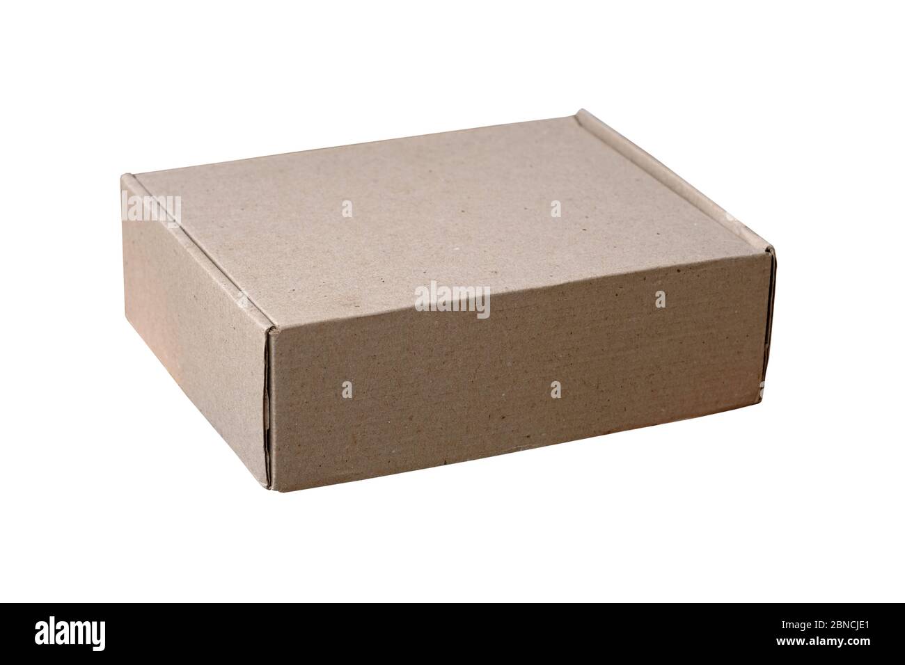 Cardboard box on a white background isolate. Closed brown box home delivery. A small rectangular box for storing things and parcels. Stock Photo