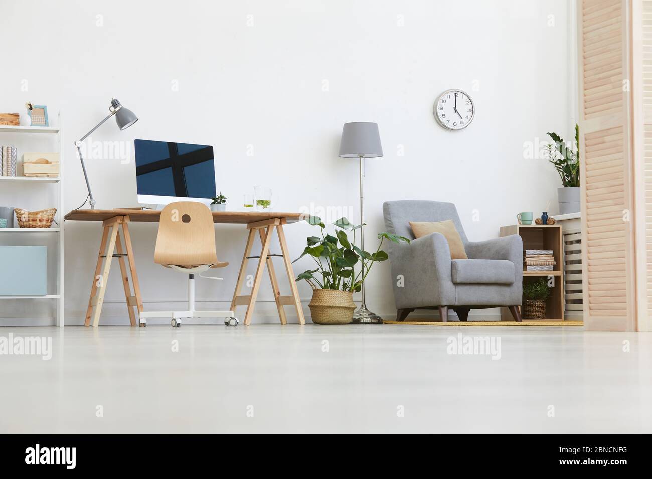 Image of workplace with computer monitor and armchair in the living room at home Stock Photo