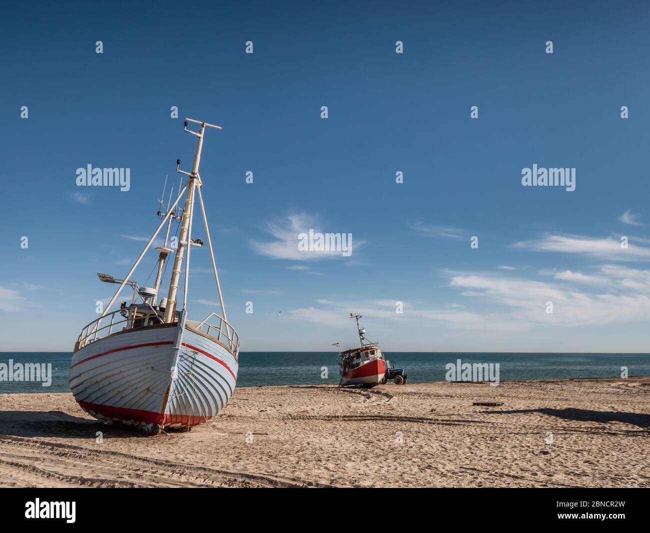 Coastal fishing boats on the beach at Thorup Strand at the North Sea in