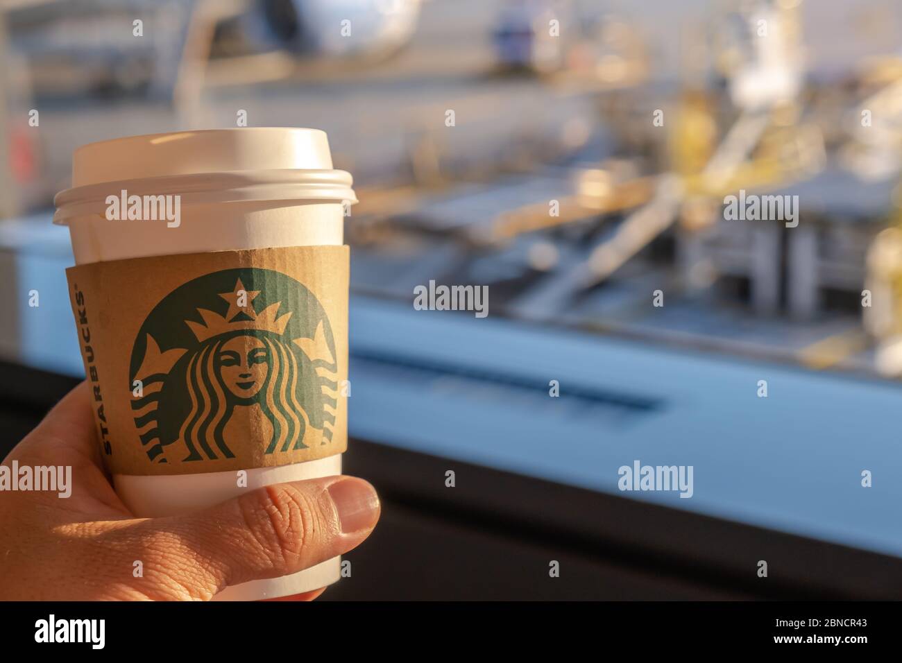 https://c8.alamy.com/comp/2BNCR43/chiba-japan-march-24-2019-hand-holding-starbucks-coffee-cup-with-brand-logo-at-narita-international-airport-chiba-japan-2BNCR43.jpg