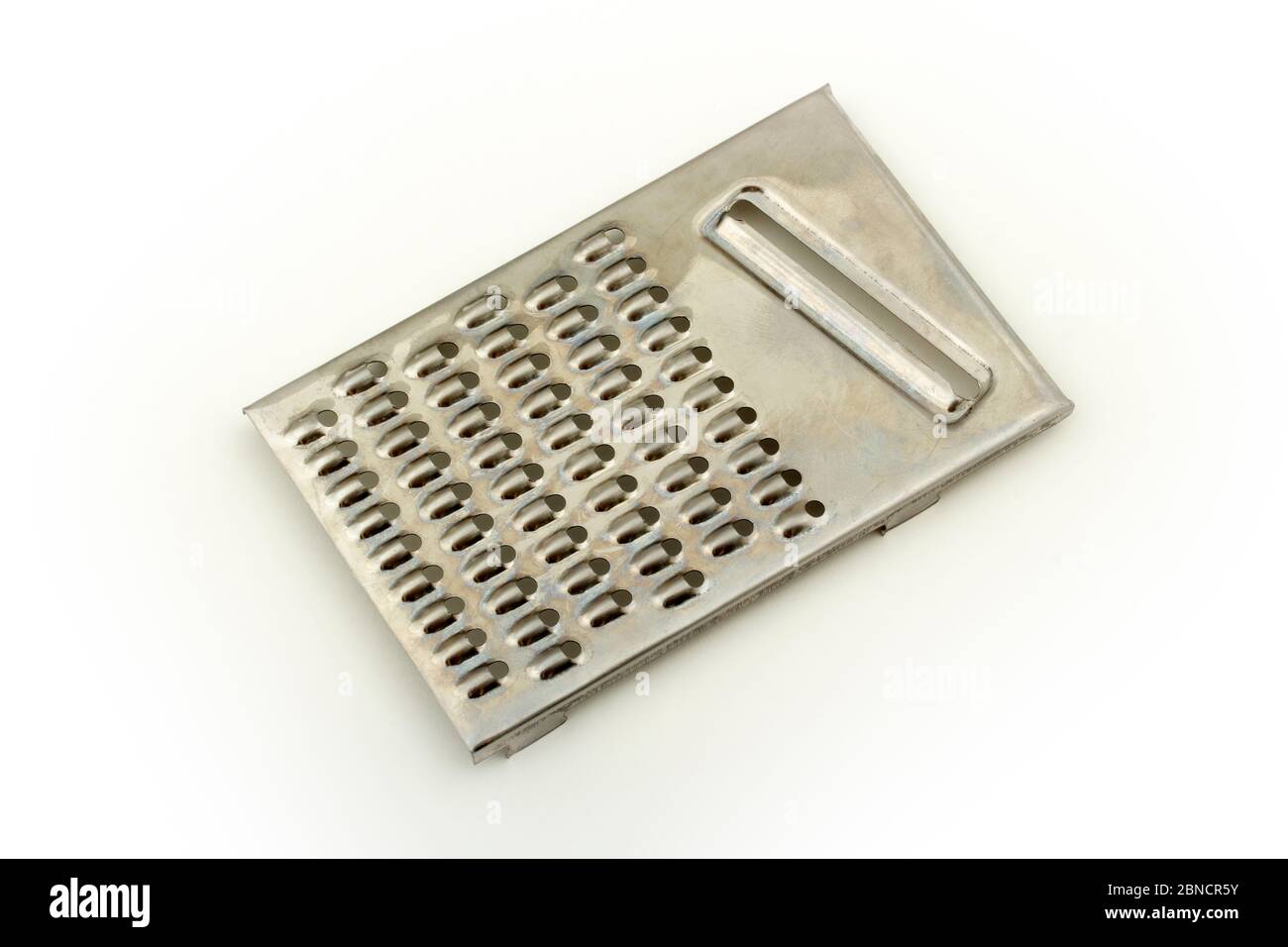 Grater in stainless steel isolated on white background /// cheese shredder  slicer cut out kitchen utensil tool kitchenware stainless object equipment  Stock Photo - Alamy