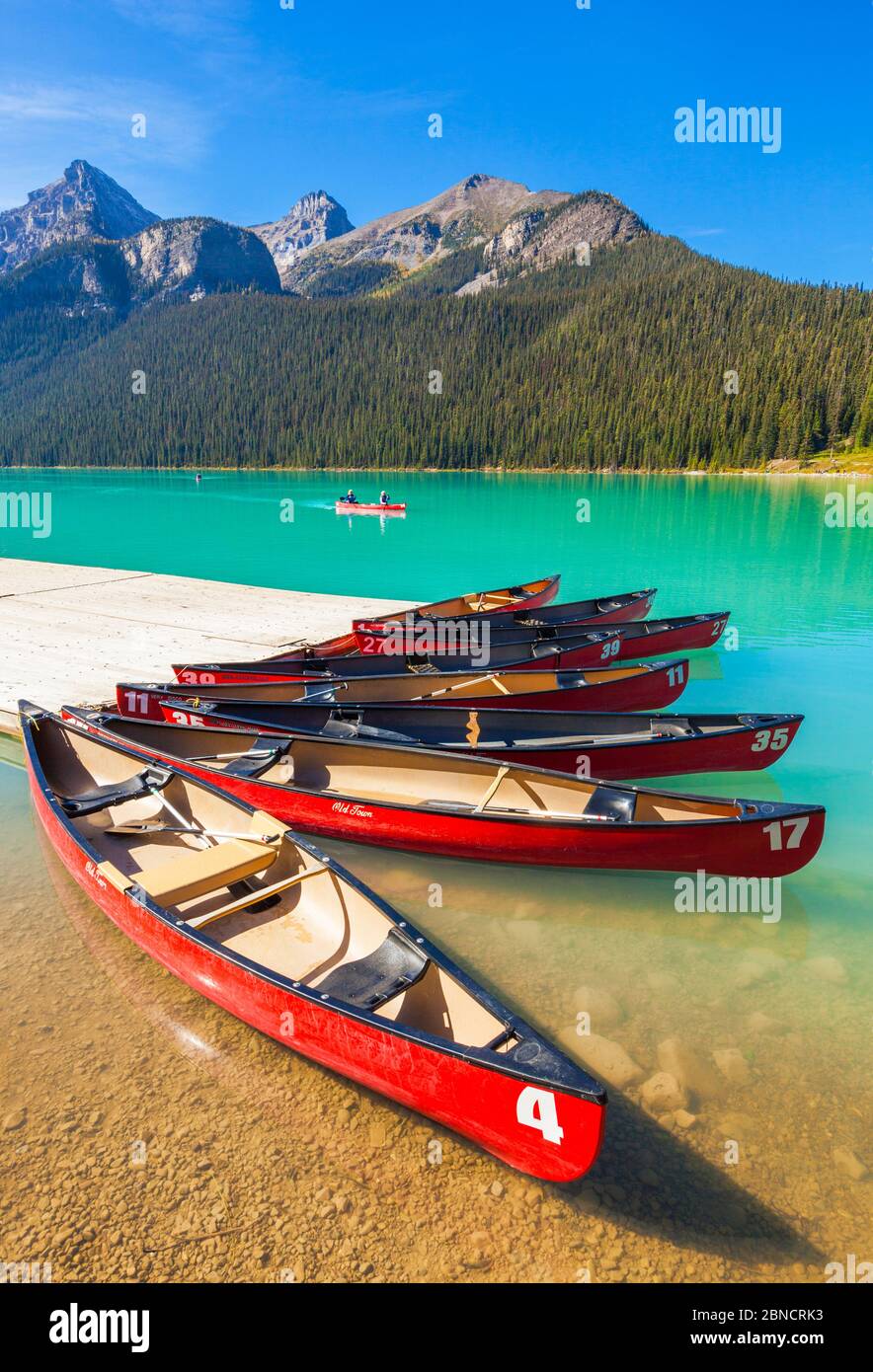 Lake Louise canoes Red canoes for hire on Lake Louise Banff national Park Alberta Canadian Rockies Canada Stock Photo