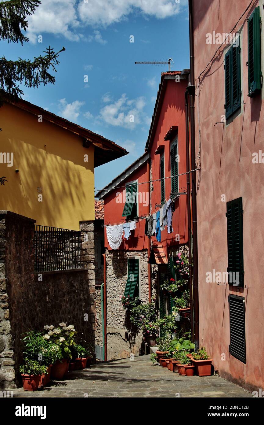Vertical shot of colorful houses and laundry in Italy Stock Photo - Alamy