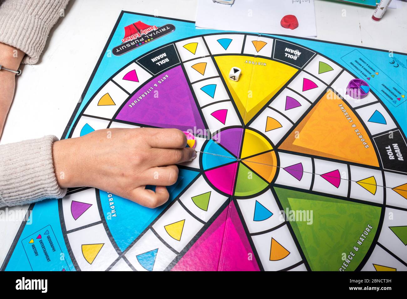 Playing  Trivial Pursuit  board game Stock Photo