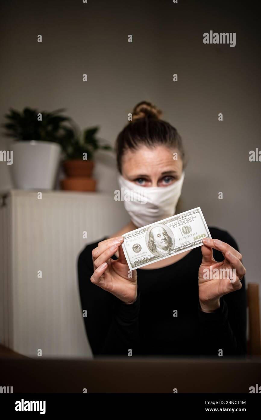 Single woman counting money bills during coronavirus time. Stock Photo