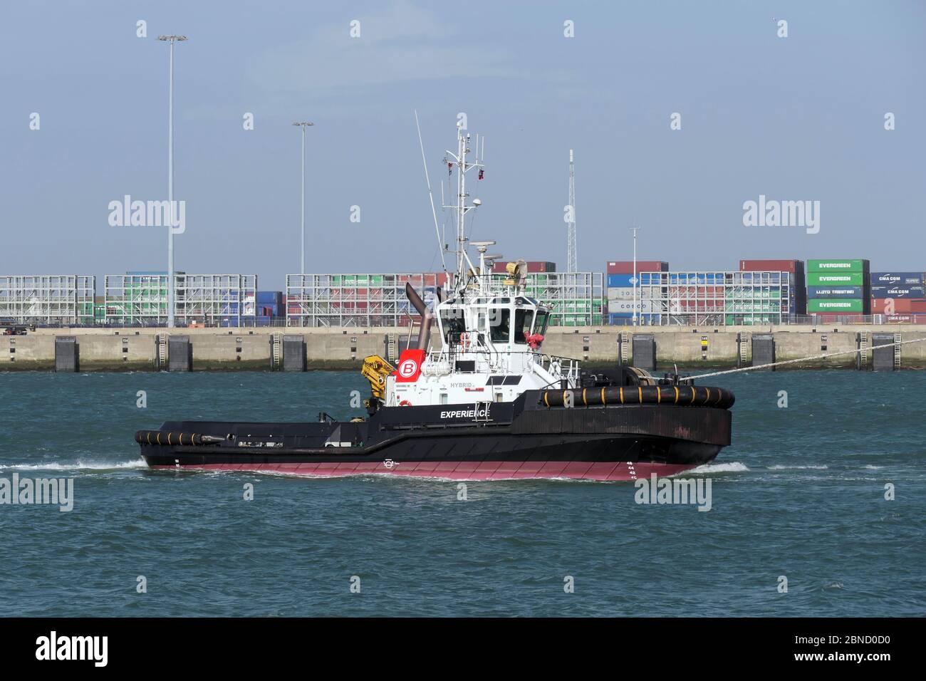 The harbor tug Experience will work in the port of Rotterdam on March 12, 2020. Stock Photo