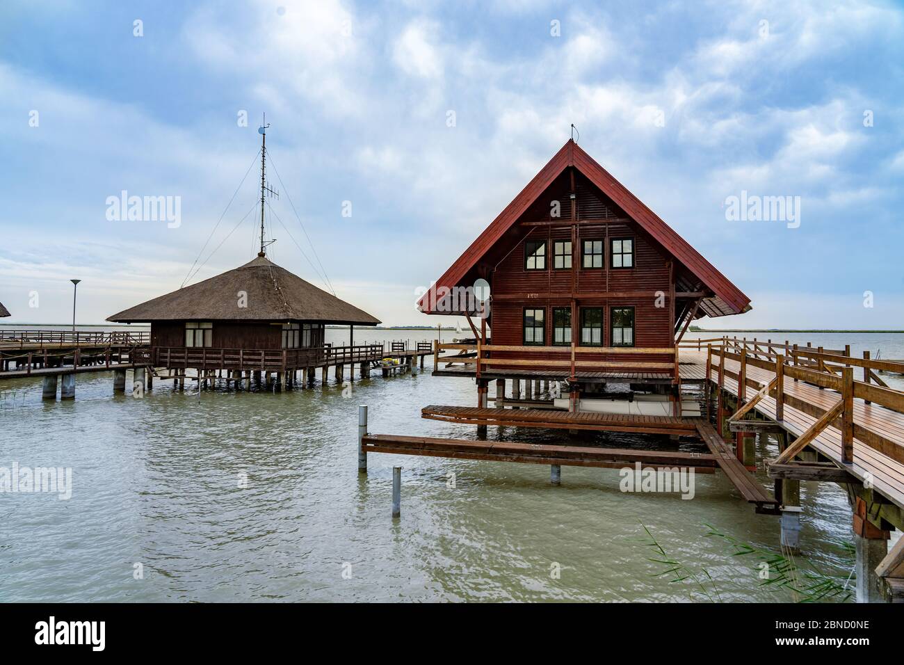 peaceful nature at the Lake Fertő in Hungary with wooden pier bungalows cabins on the lake Stock Photo