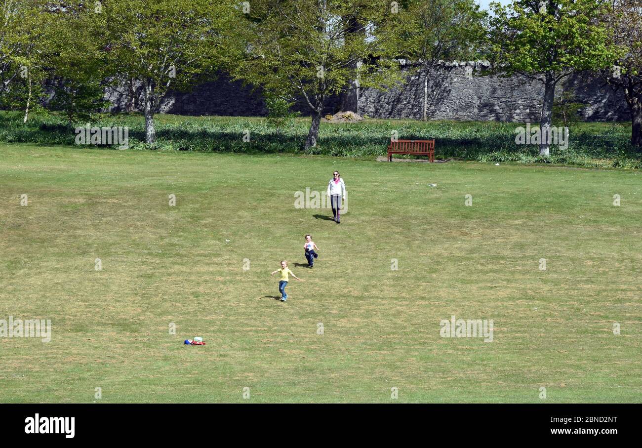 Peebles Scottish Borders, UK .14th May 20 . Coronavirus Covid-19 pandemic daily life during lockdown. Exercise. Young mother with children Hay Lodge Park. Credit: eric mccowat/Alamy Live News Stock Photo