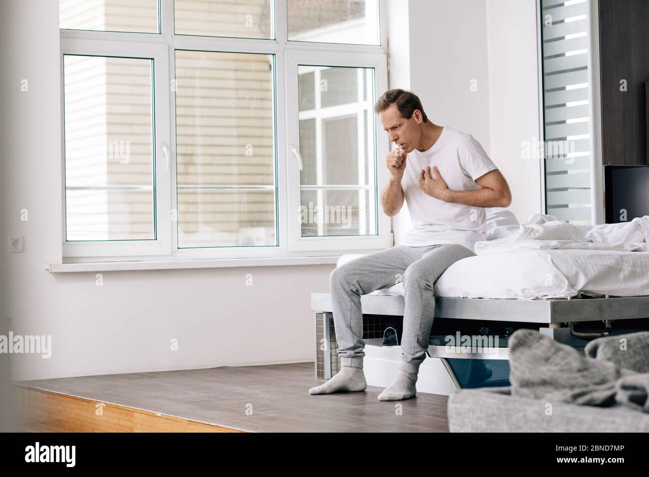 Sick man coughing sitting home hi-res stock photography and images - Alamy
