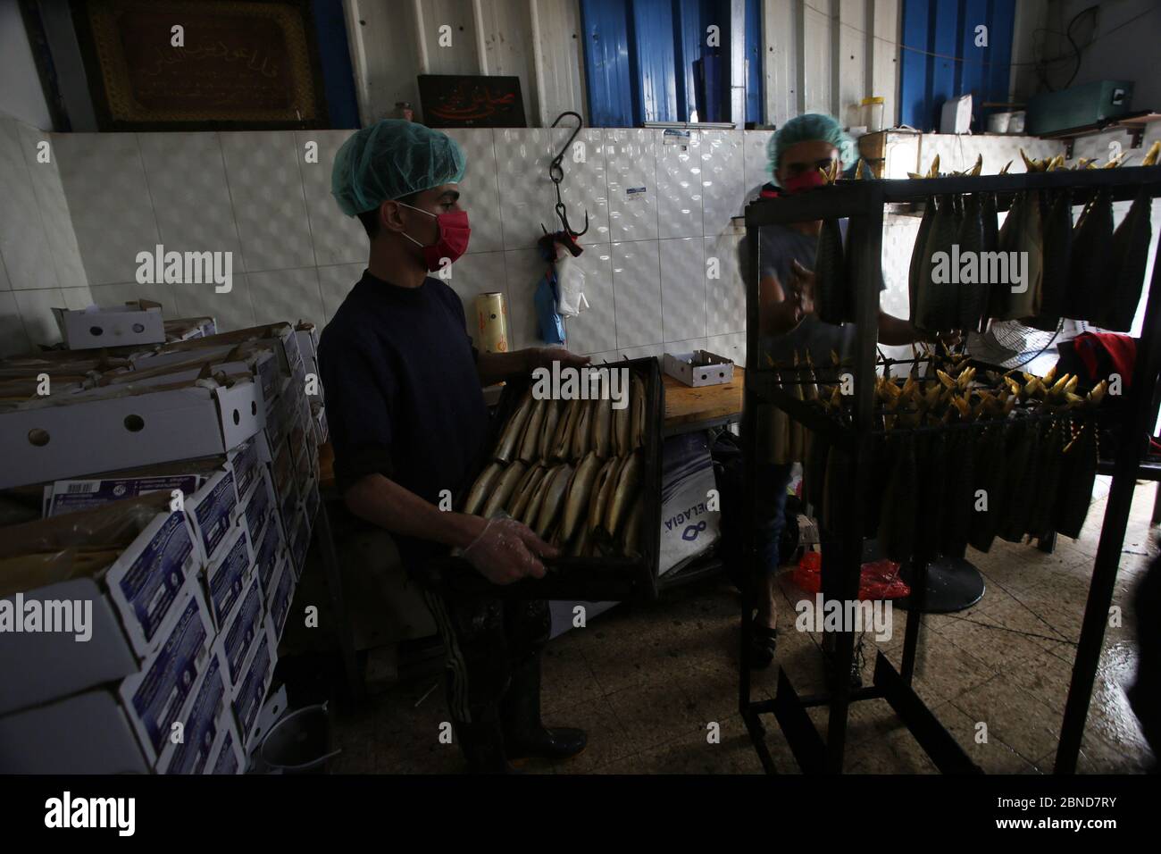 Rafah, Gaza. 14th May, 2020. Palestinian men prepare smoked mackerels before selling them during the Muslim fasting month of Ramadan in Rafah, in the southern Gaza Strip, on Wednesday, May 13, 2020. Photo by Ismael Mohamad/UPI Credit: UPI/Alamy Live News Stock Photo