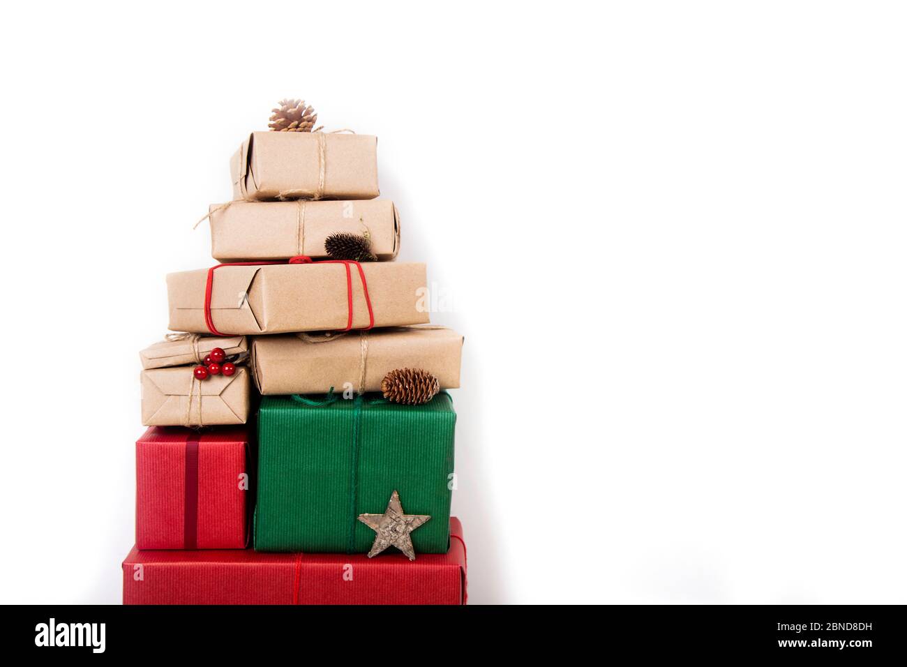 A pile of Christmas gifts in red, green and natural wrapping with ...