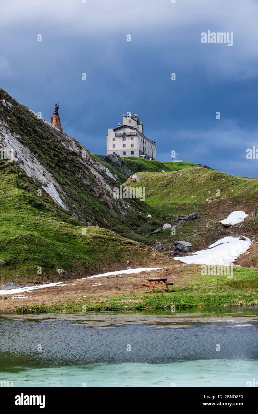 The Petit-Saint-Bernard hospice,  and statue of Saint Bernard de Menthon at the Little St Bernard Pass, French Italian border, Alps, June 2015 Stock Photo