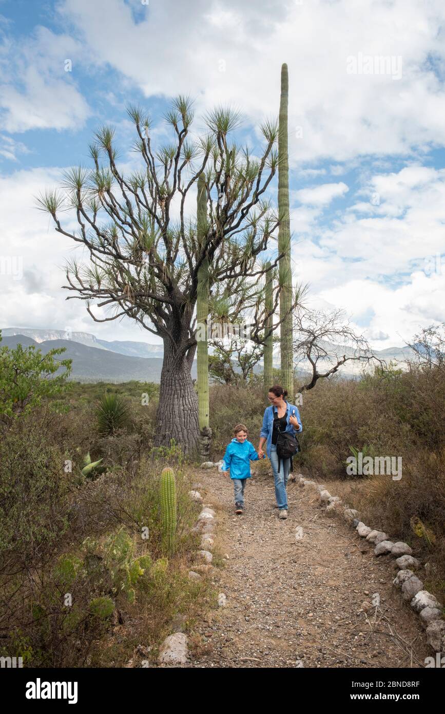 Mom and her son smiling hike on a trail in the desert Stock Photo