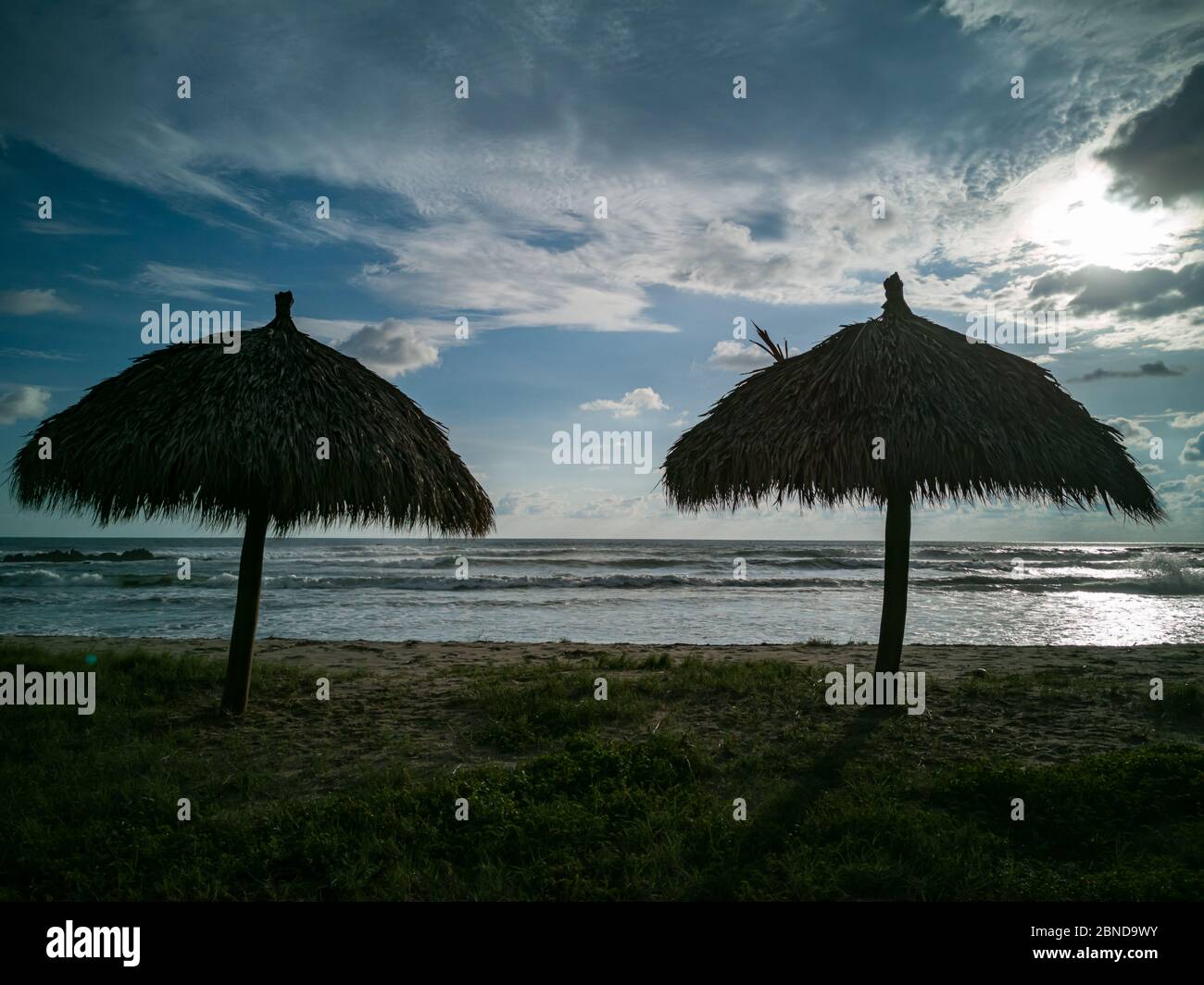 Pair of umbrellas on the beach. Stock Photo