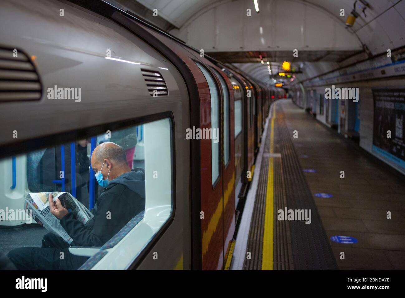 Commuter Wearing Facemask On London Underground Train With Quiet Platform Stock Photo Alamy Commuter Wearing Facemask On London Underground Train With Quiet Platform Stock Photo Alamy