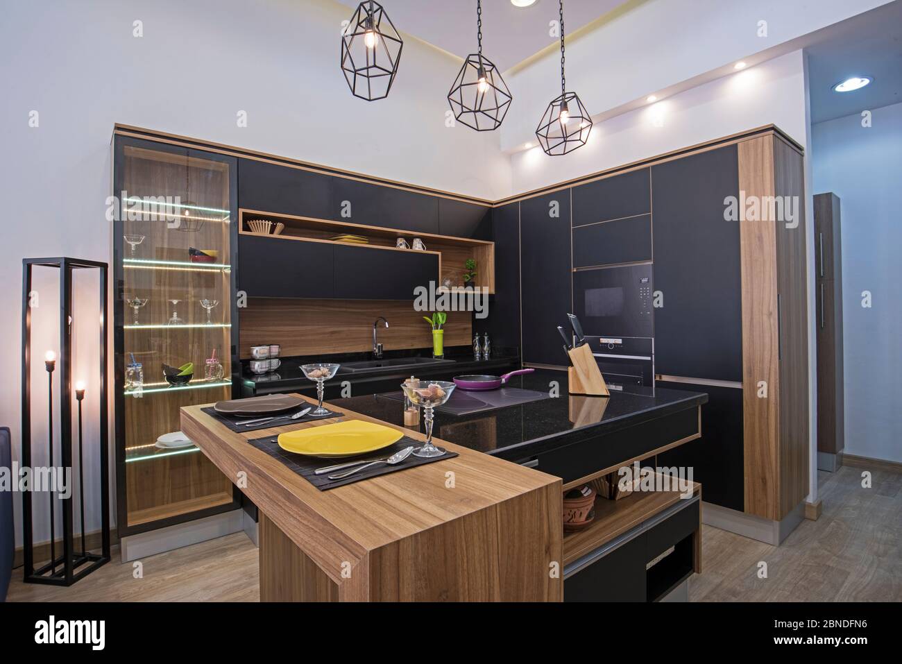 Interior design decor showing modern kitchen with cupboards and island in luxury apartment showroom Stock Photo