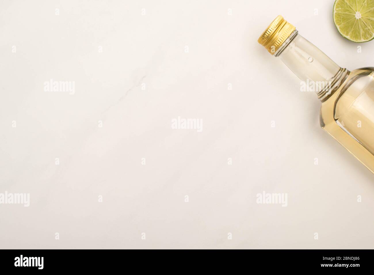 Download Top View Of Golden Tequila In Bottle With Lime On White Marble Surface Stock Photo Alamy Yellowimages Mockups
