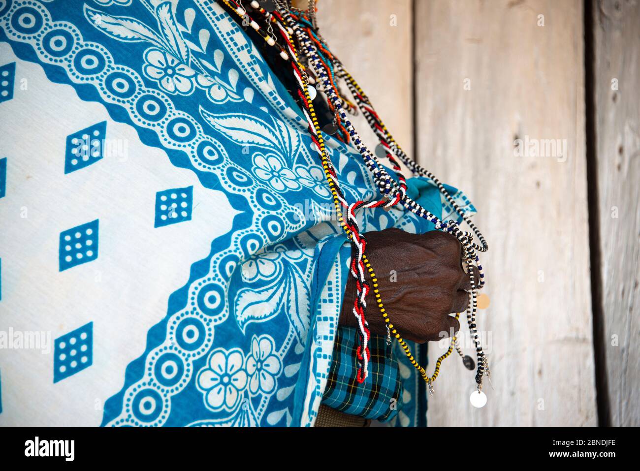 Maasai woman's hands in traditional clothing Stock Photo