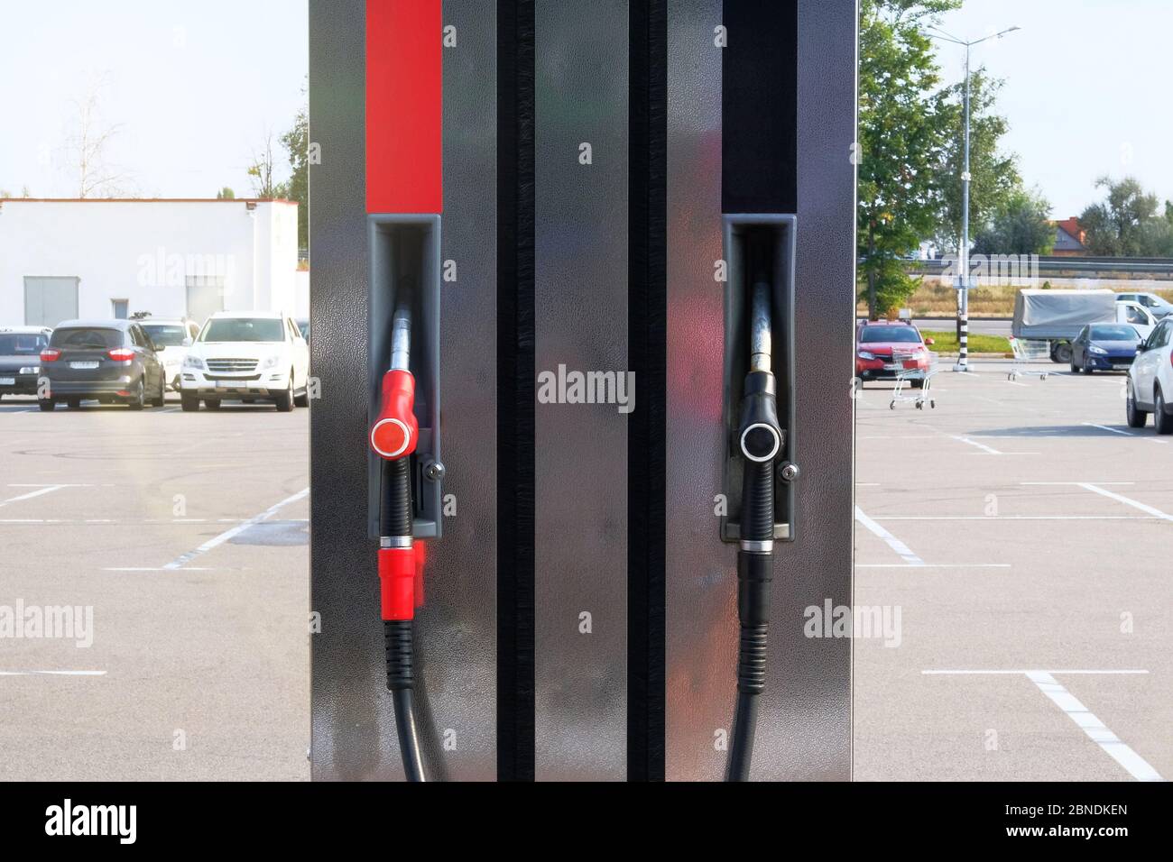 Black and red fuel pistols on fuel station. Gasoline and petrol products concept. Pumping petrol at gasoline pump. Stock Photo