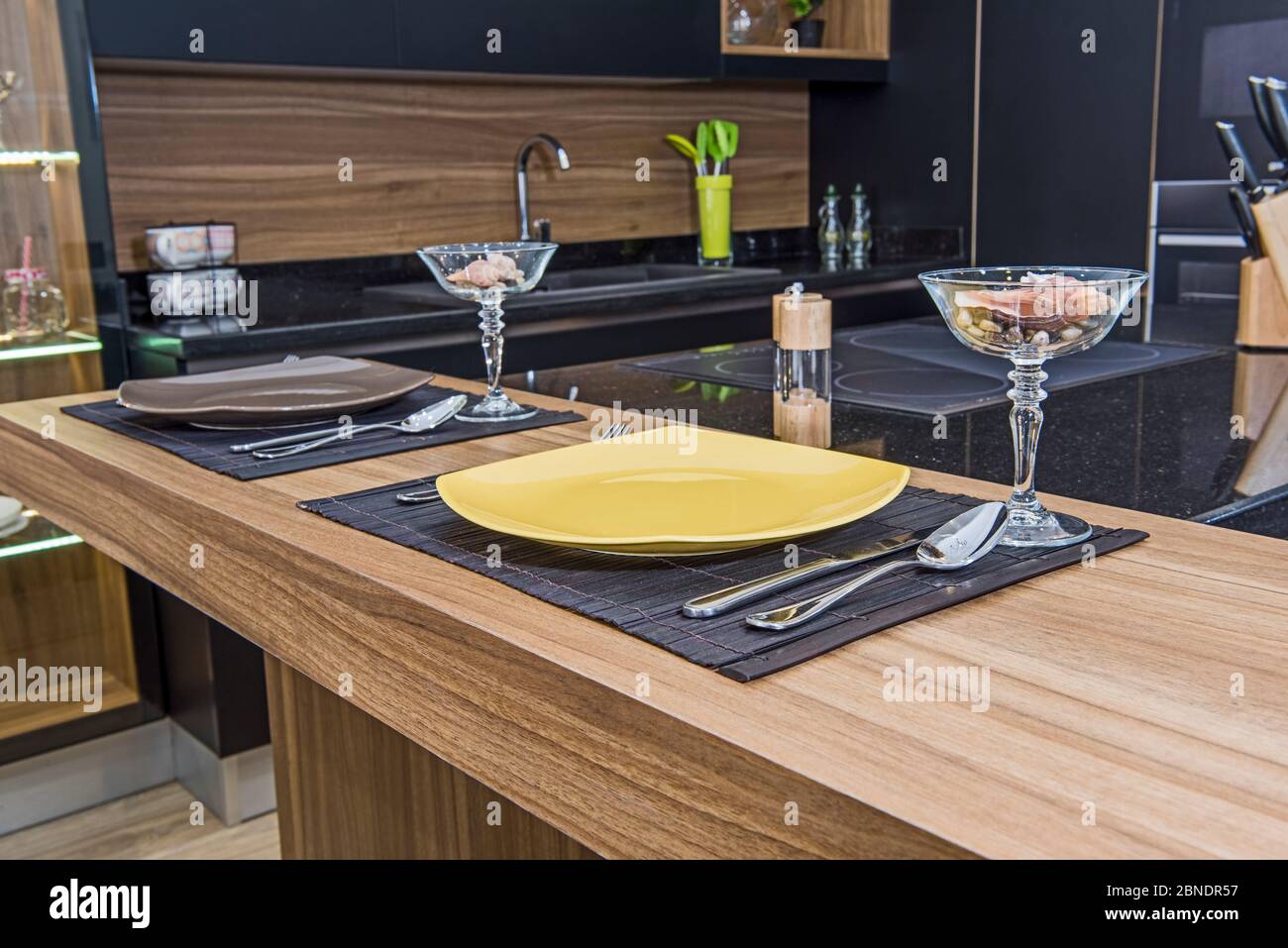 Interior design decor showing closeup of kitchen island breakfast bar in luxury apartment showroom Stock Photo