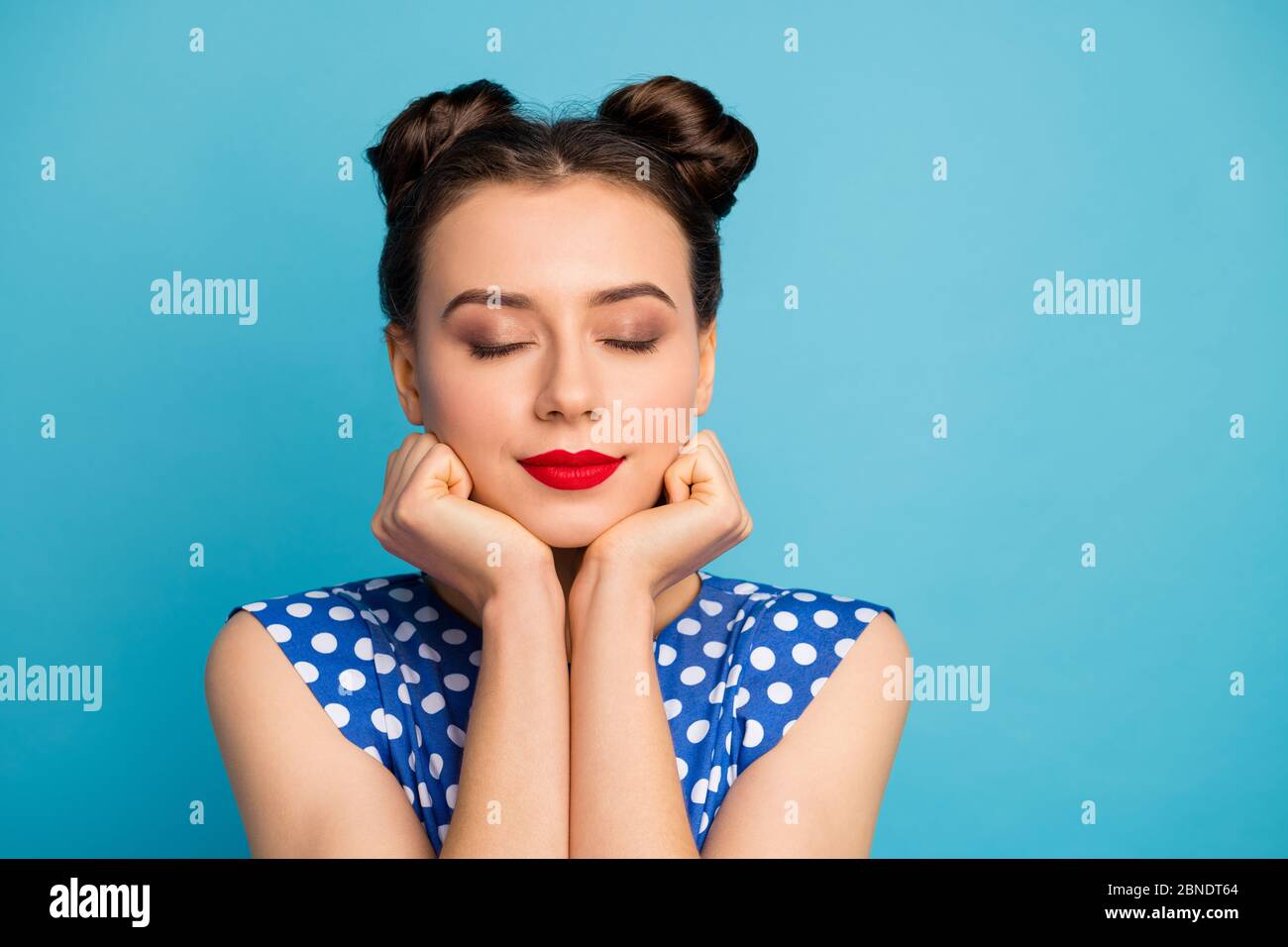 Closeup photo of pretty charming lady red pomade eyes closed hold hands Closeup photo of pretty charming lady red pomade eyes closed hold hands