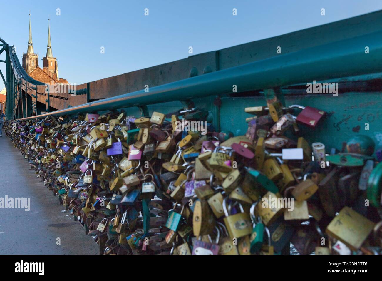 Love padlocks on Grunwaldzki Bridge, with Cathedral of St. John the Baptist behind, Wroclaw Stock Photo