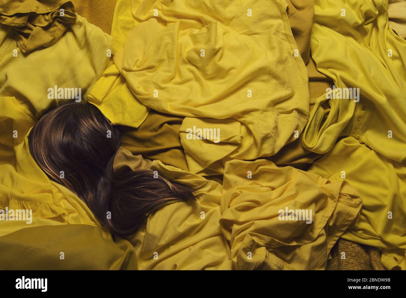 Woman buried under clothes hires stock photography and images Alamy