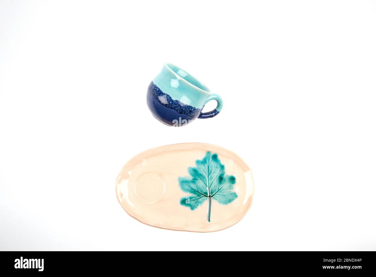 colorful handmade ceramic cups on white background isolated Stock Photo