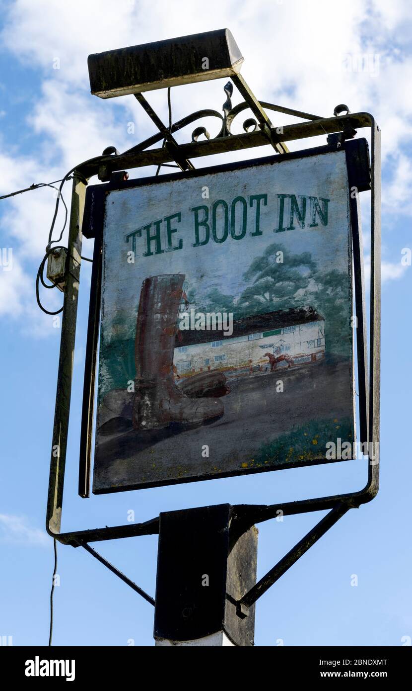 Traditional hanging pub sign at The Boot Inn - public house - Church Lane, Houghton, Stockbridge, Hampshire, England, UK Stock Photo