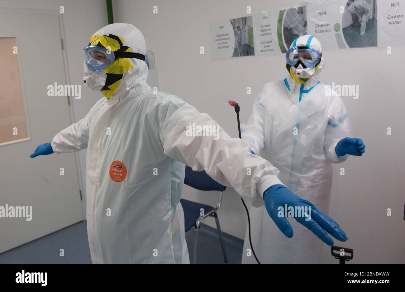 (200514) -- MOSCOW, May 14, 2020 (Xinhua) -- A medical worker wearing personal protective equipment (PPE) disinfects her colleague at the National Medical Research Center for Endocrinology where patients suffering from COVID-19 are treated in Moscow, Russia, on May 14, 2020. Russia has confirmed 9,974 new COVID-19 cases in the past 24 hours, raising its total number of infections to 252,245, its coronavirus response center said in a statement Thursday. Global confirmed COVID-19 cases topped 4.4 million on Thursday, reaching 4,405,019 as of 12:32 p.m. (1632 GMT), according to the Center for Sys Stock Photo