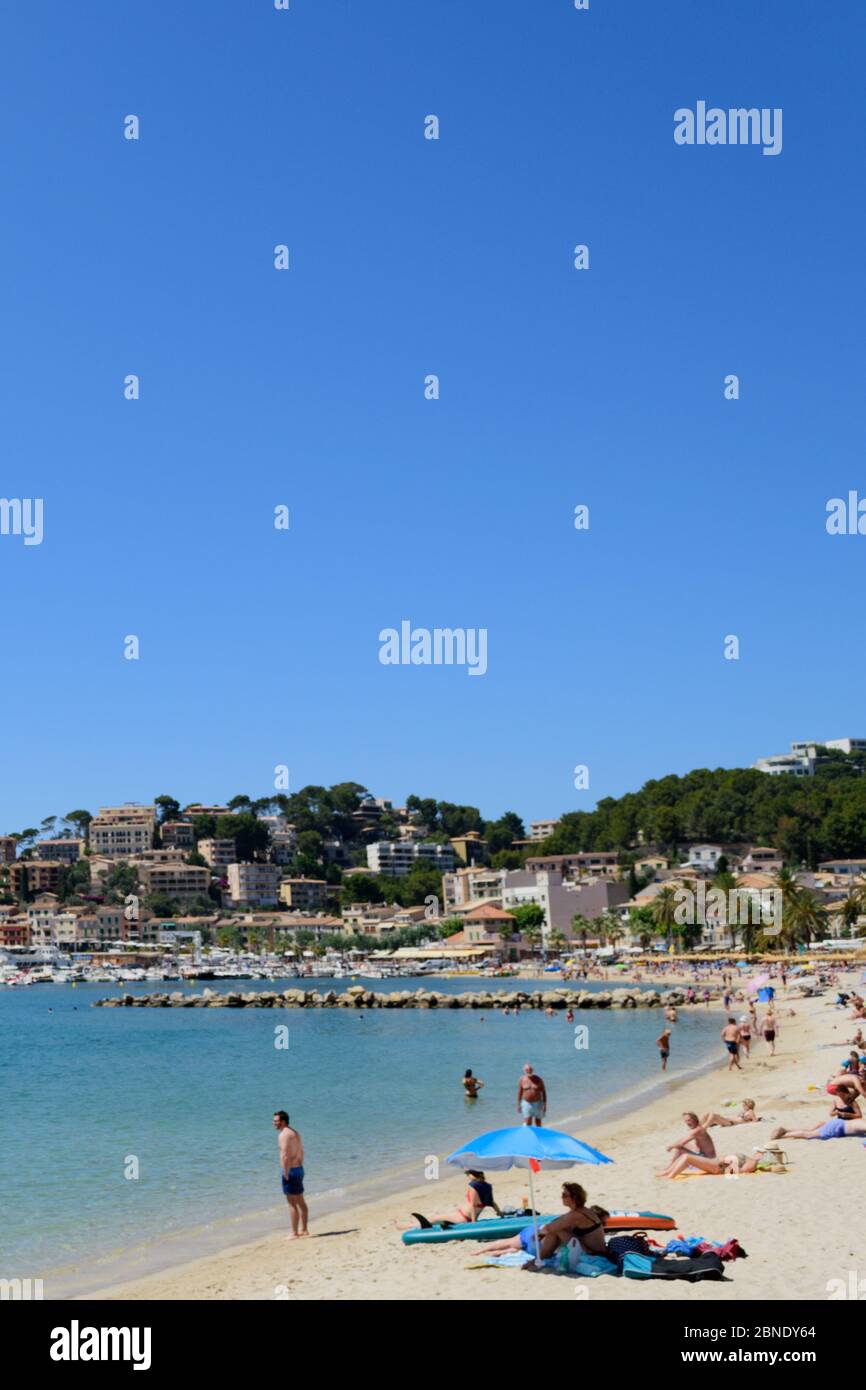 Majorca, Spain - June 18th, 2019. Visitors enjoying a sunny day at the beach in the coastal town of Puerto de Soller Stock Photo