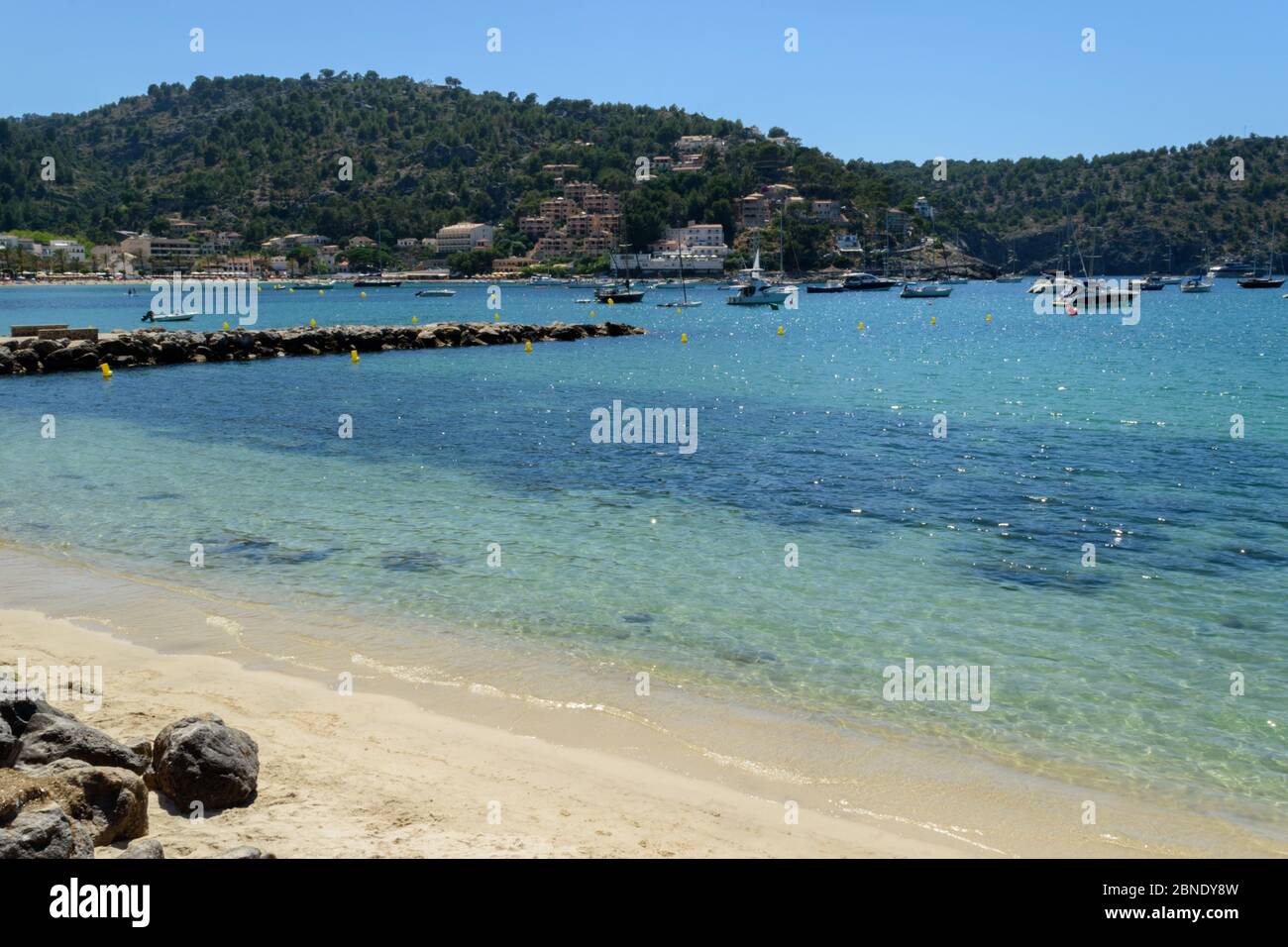 Beautiful clear blue water at the beach in Port de Soller, Mallorca, Spain Stock Photo
