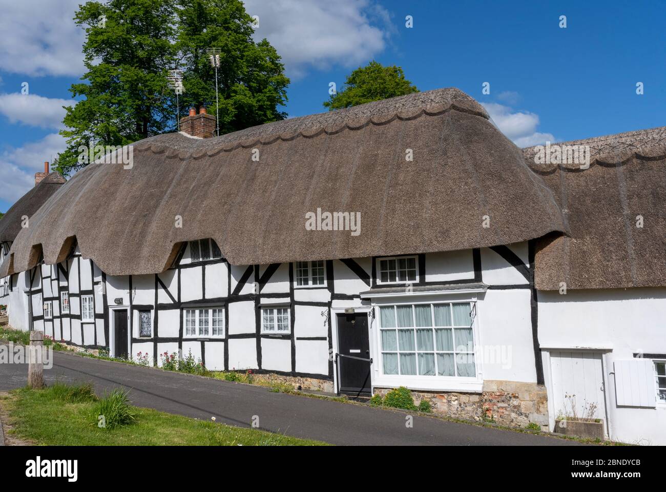 Row of timber framed thatched cottages in the Hampshire Village of Wherwell, Test Valley, Hampshire, England, UK. Stock Photo