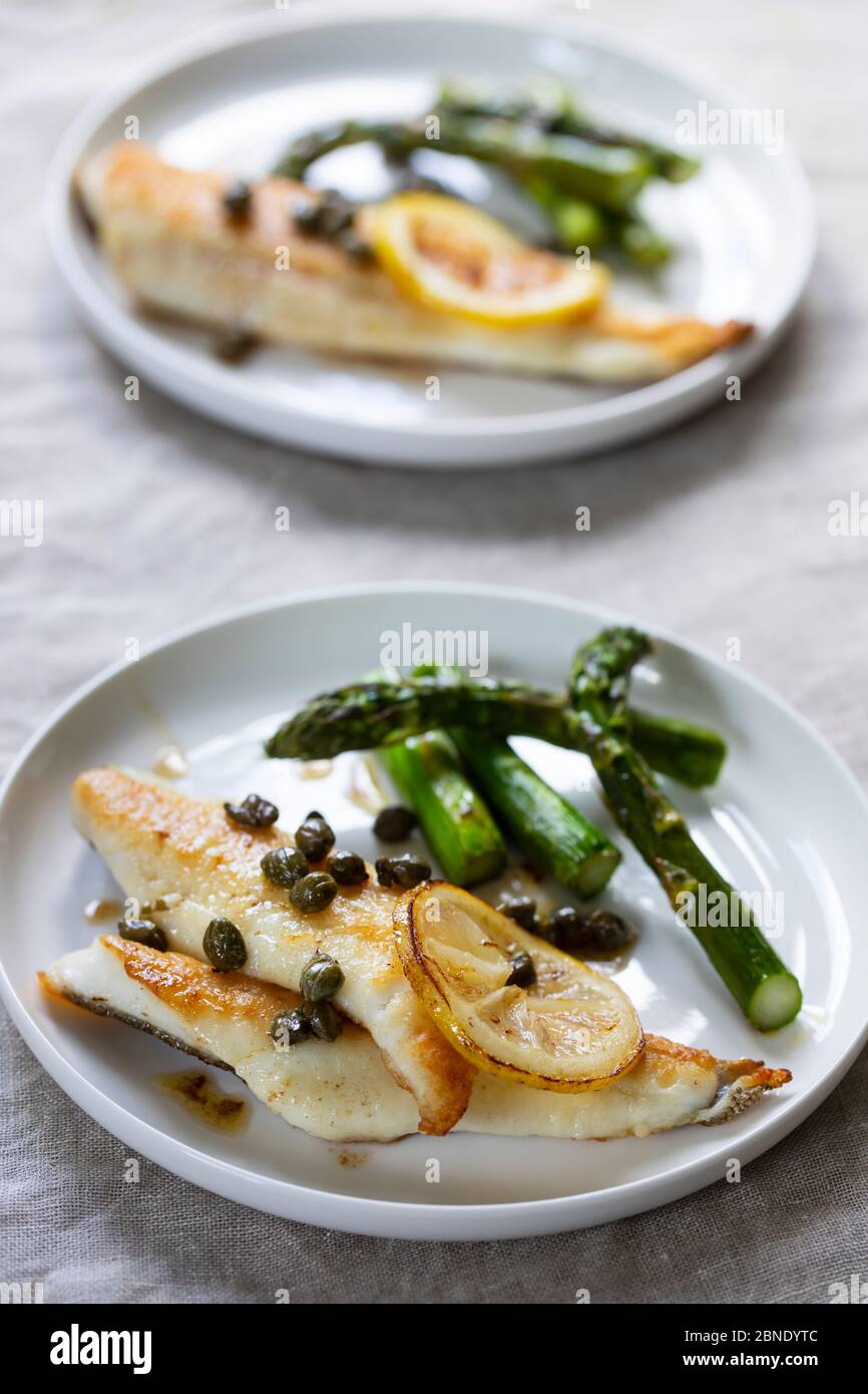 Lemon sole with butter and capers sauce and asparagus Stock Photo Alamy